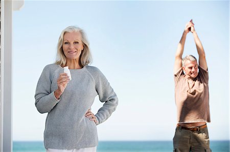 stretch outdoors - Couple enjoying on the beach Stock Photo - Premium Royalty-Free, Code: 6108-06906844