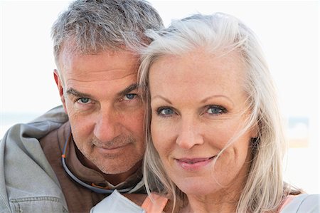 Portrait of a couple smiling on the beach Stock Photo - Premium Royalty-Free, Code: 6108-06906865