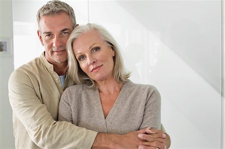 senior couple smile portrait - Man hugging his wife from behind Stock Photo - Premium Royalty-Free, Code: 6108-06906868