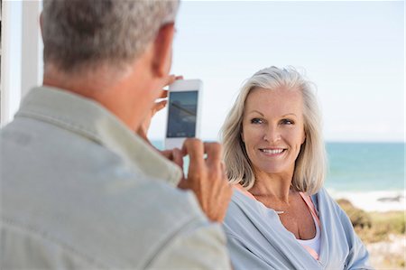 south africa camera - Man taking a picture of his wife with a cell phone on the beach Stock Photo - Premium Royalty-Free, Code: 6108-06906870