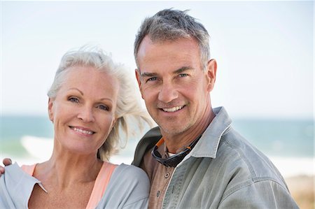 Portrait of a couple smiling on the beach Stock Photo - Premium Royalty-Free, Code: 6108-06906886