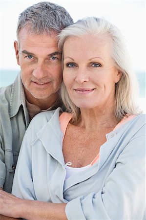 Portrait of a couple smiling on the beach Stock Photo - Premium Royalty-Free, Code: 6108-06906898