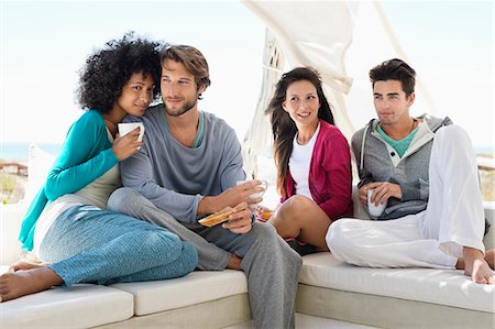 friendship shadows - Smiling friends enjoying coffee on the terrace Stock Photo - Premium Royalty-Free, Code: 6108-06906806