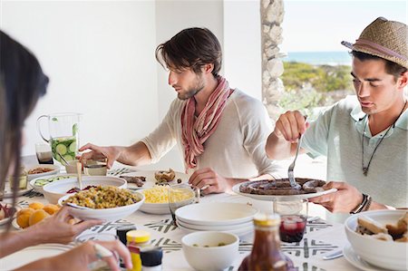 eating with friends not child not restaurant not outdoor - Friends eating lunch at dining table Stock Photo - Premium Royalty-Free, Code: 6108-06906824