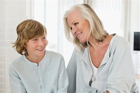 simsearch:6108-06906902,k - Woman and her grandson smiling Photographie de stock - Premium Libres de Droits, Code: 6108-06906902