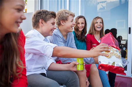 drinking smile boy - Friends enjoying fast food together Stock Photo - Premium Royalty-Free, Code: 6108-06907050