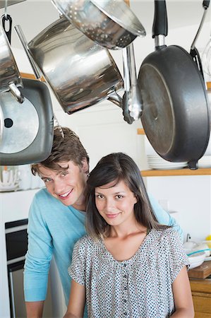 simsearch:6108-06907063,k - Portrait of a couple smiling in the kitchen Stock Photo - Premium Royalty-Free, Code: 6108-06907059