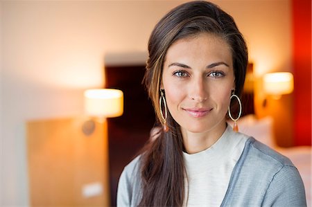 portrait casual indoors not mature not child - Portrait of a woman in a hotel room Stock Photo - Premium Royalty-Free, Code: 6108-06907145