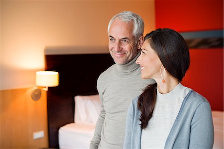 simsearch:6108-06907854,k - Couple smiling in a hotel room Stock Photo - Premium Royalty-Free, Code: 6108-06907168