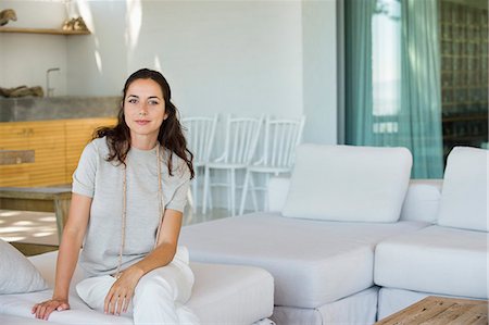 decoration home - Portrait of a beautiful woman sitting on a couch Stock Photo - Premium Royalty-Free, Code: 6108-06907189