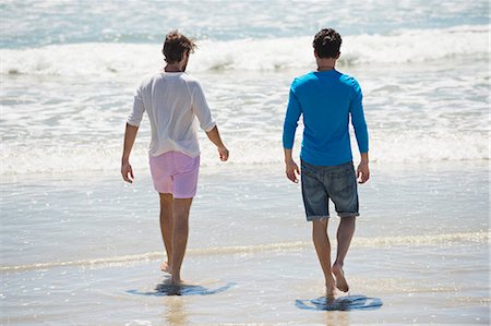 simsearch:6108-06907307,k - Two men walking on the beach Stock Photo - Premium Royalty-Free, Code: 6108-06907349