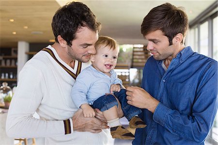 photo of happy family stand front of home - Parents with their son at home Stock Photo - Premium Royalty-Free, Code: 6108-06907321