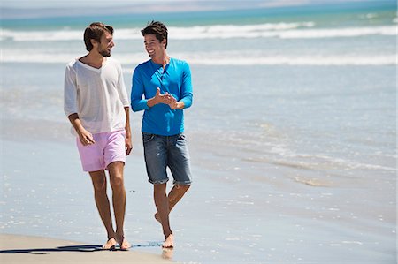 friends beach not kids - Two men walking on the beach Stock Photo - Premium Royalty-Free, Code: 6108-06907327