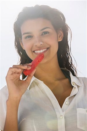 simsearch:632-06029502,k - Beautiful woman eating a slice of watermelon on the beach Stock Photo - Premium Royalty-Free, Code: 6108-06907407