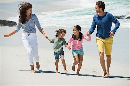 simsearch:6108-06905893,k - Family enjoying on the beach Stock Photo - Premium Royalty-Free, Code: 6108-06907543