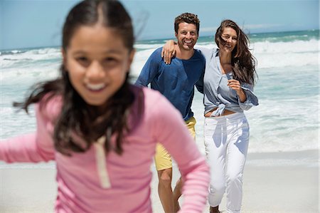 Family enjoying on the beach Stock Photo - Premium Royalty-Free, Code: 6108-06907548