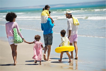 dad son hold hand walk back - Family enjoying vacations on the beach Stock Photo - Premium Royalty-Free, Code: 6108-06907592