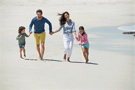 four people - Family enjoying on the beach Stock Photo - Premium Royalty-Free, Code: 6108-06907594
