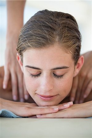 Woman receiving back massage from a massage therapist Stock Photo - Premium Royalty-Free, Code: 6108-06907521