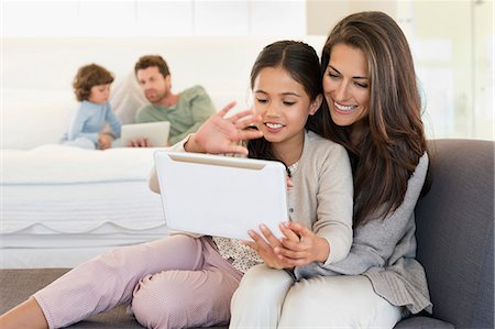 Woman and her daughter looking at a digital tablet Stock Photo - Premium Royalty-Free, Code: 6108-06907644