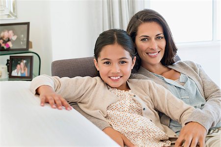 portrait girl smiling - Portrait of a woman and her daughter smiling Stock Photo - Premium Royalty-Free, Code: 6108-06907645