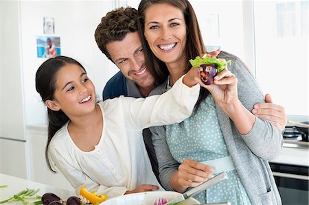 simsearch:6108-06166806,k - Couple with their daughter enjoying in the kitchen Stock Photo - Premium Royalty-Free, Code: 6108-06907638