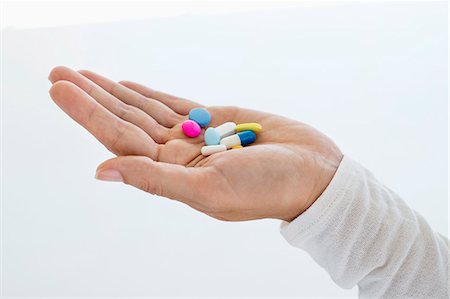 Close-up of a woman's hand holding medicines Stock Photo - Premium Royalty-Free, Code: 6108-06907759