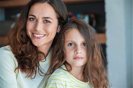 Portrait of a woman smiling with her daughter Stock Photo - Premium Royalty-Free, Code: 6108-06907827