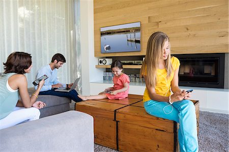 family wireless living room - Family using electronics gadgets Stock Photo - Premium Royalty-Free, Code: 6108-06907832