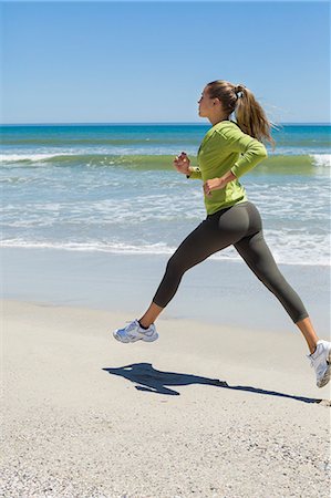 running blonde woman - Woman jogging on the beach Stock Photo - Premium Royalty-Free, Code: 6108-06907982