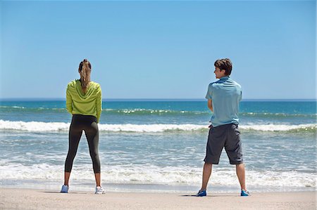 Rear view of a woman and her coach exercising on the beach Photographie de stock - Premium Libres de Droits, Code: 6108-06907988