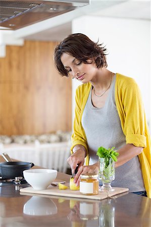pan on stove - Woman preparing herbal tea in the kitchen Stock Photo - Premium Royalty-Free, Code: 6108-06908077