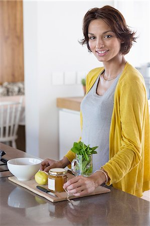 Woman preparing herbal tea in the kitchen Stock Photo - Premium Royalty-Free, Code: 6108-06908075