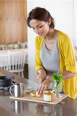Woman preparing herbal tea in the kitchen Stock Photo - Premium Royalty-Free, Code: 6108-06908078