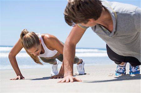 sand workout - Woman exercising on the beach with her coach Stock Photo - Premium Royalty-Free, Code: 6108-06908001