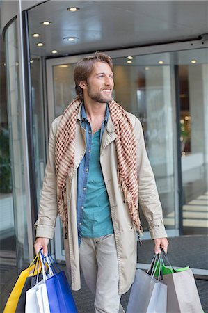 shopping jacket - Man carrying shopping bags and smiling Stock Photo - Premium Royalty-Free, Code: 6108-06908121