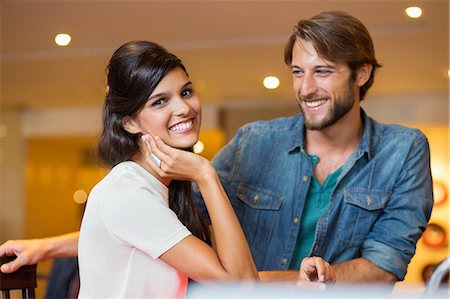 people standing at bar - Portrait of a woman smiling with her friend beside her Stock Photo - Premium Royalty-Free, Code: 6108-06908131