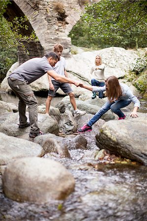 Family in a stream Stock Photo - Premium Royalty-Free, Code: 6108-07969547