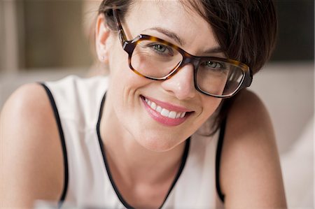 eyeglasses - Portrait of a beautiful woman smiling Stock Photo - Premium Royalty-Free, Code: 6108-07969516