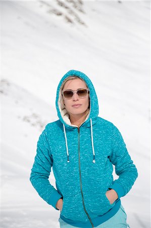 Beautiful woman standing in snow, Crans-Montana, Swiss Alps, Switzerland Stock Photo - Premium Royalty-Free, Code: 6108-08105288