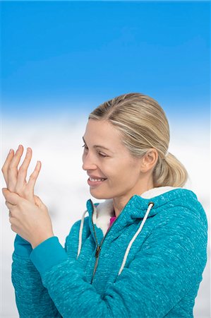 Beautiful happy woman applying moisturizer, Crans-Montana, Swiss Alps, Switzerland Stock Photo - Premium Royalty-Free, Code: 6108-08105291