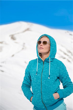 Beautiful woman standing in snow, Crans-Montana, Swiss Alps, Switzerland Stock Photo - Premium Royalty-Free, Code: 6108-08105297