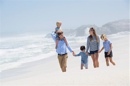 romance - Family walking on the beach Stock Photo - Premium Royalty-Free, Code: 6108-08662362