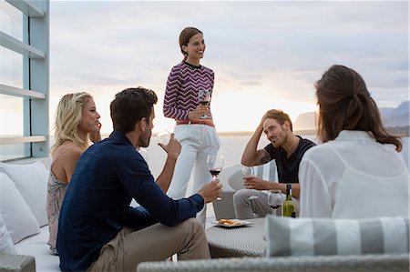 Group of friends enjoying wine at a resort Stock Photo - Premium Royalty-Free, Code: 6108-08662508