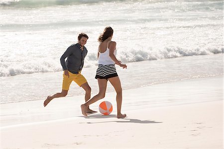 simsearch:6108-08662619,k - Happy young couple playing with a beach ball Stock Photo - Premium Royalty-Free, Code: 6108-08662665