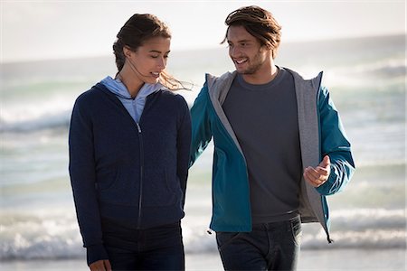 simsearch:6108-08662619,k - Happy young couple walking on beach Stock Photo - Premium Royalty-Free, Code: 6108-08662633