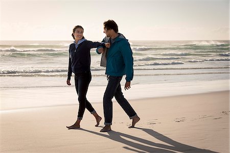 simsearch:6108-08662619,k - Happy young couple walking on beach Stock Photo - Premium Royalty-Free, Code: 6108-08662635