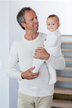 simsearch:6108-08663387,k - Happy father with his cute baby daughter at home Photographie de stock - Premium Libres de Droits, Code: 6108-08662759