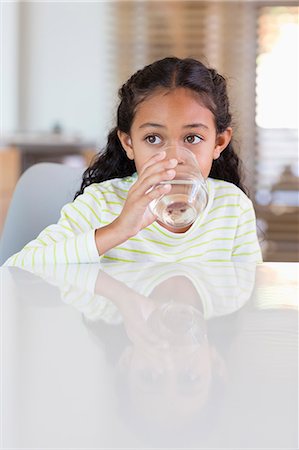 simsearch:6108-06167259,k - Little girl drinking a glass of water at home Stock Photo - Premium Royalty-Free, Code: 6108-08662784