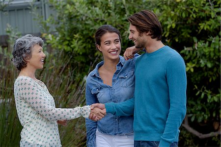 friend talking outdoors not children not bathing suit not school not beach not business - Happy mature woman meet with young couple outside Photographie de stock - Premium Libres de Droits, Code: 6108-08662700